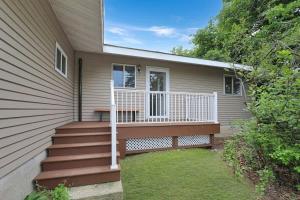 a house with a porch with a wooden deck at Amazing Grace Etta Shores in Henning