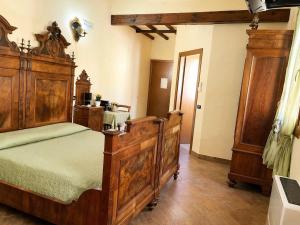 a bedroom with a large wooden bed in a room at B&B Il Fiocinino in Comacchio +2 photos