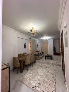 a living room with a table and a couch at Spacious Apartment In 6 October in 6th Of October