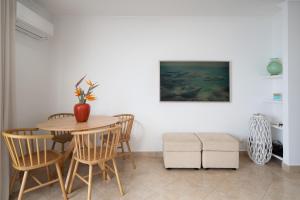 a dining room with a table and chairs at Lighthouse - Exclusive Sea view 180º, pool, parking in Portimão