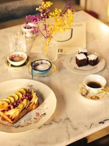 a table topped with plates of food and desserts at Blu Rooms in Galatina +14 photos