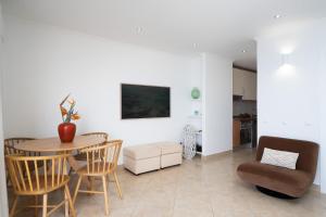 a living room with a table and chairs at Lighthouse - Exclusive Sea view 180º, pool, parking in Portimão