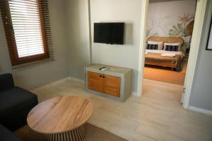 a living room with a coffee table and a couch at Alp Suites Mandalin in Akyaka