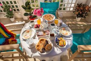 a breakfast table with breakfast foods on it at Semiramis Guesthouse in Adamas