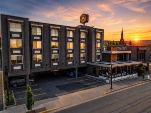 a large building with a clock on top of it at Rayland Hotel in The Dalles