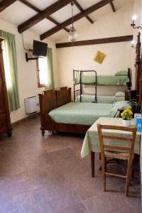 a bedroom with two beds and a table and a television at B&B Il Fiocinino in Comacchio
