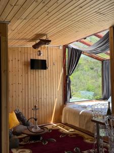 a bedroom with a bed and a large window at Mountain Paradise in Merisi 2 in Merisi