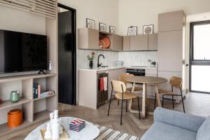 a kitchen and living room with a table and a couch at Pueblo La Dehesa in Santiago