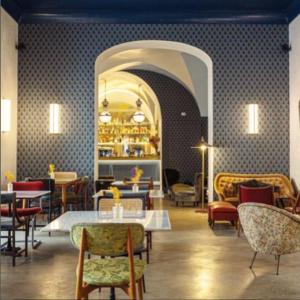a restaurant with tables and chairs in a room at Blu Rooms in Galatina