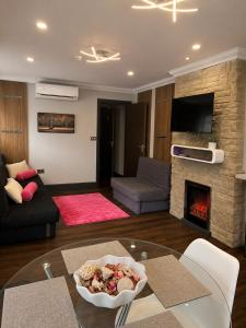 a living room with a table and a fireplace at The Bromley's in Great Yarmouth
