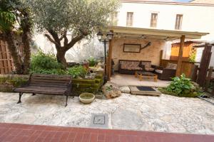 a patio with a bench and a house at B&B Il Fiocinino in Comacchio