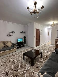 a living room with a couch and a table at Spacious Apartment In 6 October in 6th Of October