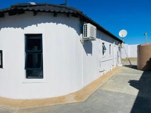 a white building with a window on the side of it at Lifestyle Villas in Sipilini