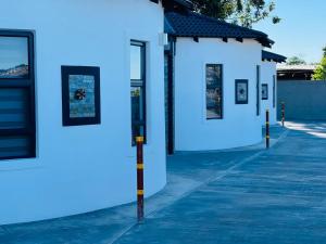 a white building with blue paint on it at Lifestyle Villas in Sipilini +15 photos