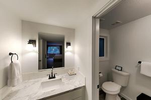 a white bathroom with a sink and a toilet at Woodinville Escape in Woodinville +20 photos
