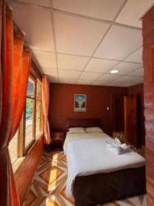 a bedroom with two beds on a train at Playita Salomon in Baños