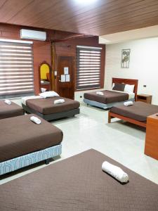 a room with three beds in a room at Salamandras Hostería & Spa in Tena +93 photos