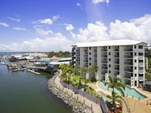 an aerial view of a building next to a marina at 2nd Floor 1-Bedroom Apartment in Urangan