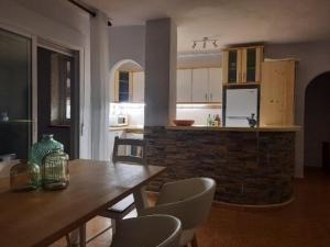 a kitchen and dining room with a table and chairs at Casa Gaia in La Manga del Mar Menor