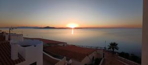 a sunset over a body of water with buildings at Casa Gaia in La Manga del Mar Menor