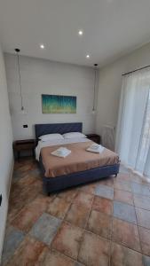 a bedroom with a large bed in a room at DIMORA REALE - Charming House Caserta in Casagiove