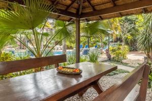 a wooden bench with a bowl of fruit on it at Paramanta Lifestyle Hotel in Asunción