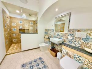 a bathroom with a toilet sink and a shower at Casa Mimi in Praiano +44 photos