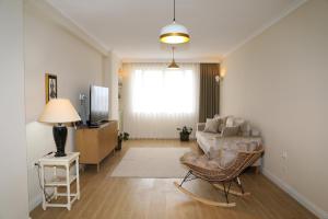 a living room with a couch and a television at City Views Apartment in Shkodër