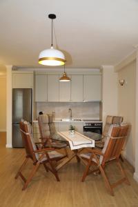 a kitchen with a table and chairs and a sink at City Views Apartment in Shkodër