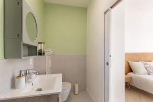 a bathroom with a sink and a toilet and a bed at Villa Anita in Chevreuse +34 photos