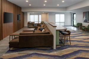 a lobby with a couch and a table and chairs at TownePlace Suites by Marriott Reno in Reno