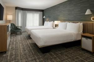 a hotel room with two beds and a television at TownePlace Suites by Marriott Reno in Reno +27 photos
