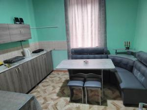 a kitchen with a table and chairs and a couch at Гостевой дом Туманян in Tʼumanyan