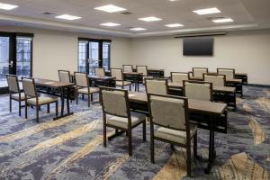 a conference room with tables and chairs and a screen at TownePlace Suites by Marriott Reno in Reno