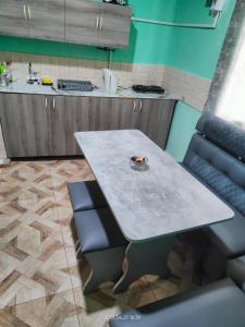 a kitchen with a table and two chairs and a counter at Гостевой дом Туманян in Tʼumanyan +13 photos