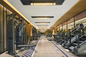 a gym with rows of treadmills and machines at Four Points by Sheraton Shanwei Lufeng in Shanwei