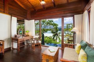 an open living room with a desk and a desk at Enchanted Island Resort in Mahe