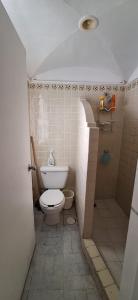 a small bathroom with a toilet and a shower at PlayaSol las Hadas in Manzanillo +12 photos