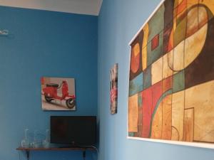 a room with a painting of a scooter on the wall at La capannina cilento cam 12 in San Marco di Castellabate