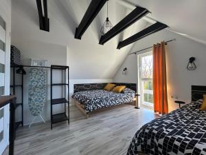 a bedroom with a bed and a window at Poprzeczna 7 in Sarbinowo