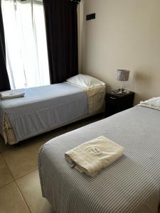 a hotel room with two beds and a towel on the bed at Complejo Anjana in Federación +86 photos
