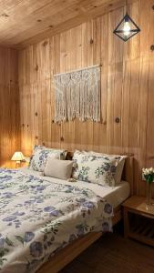 a bed in a room with wood paneled walls at Aroha Living in Bandal +22 photos