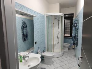 a bathroom with a toilet and a shower and a sink at Dimora C&A in Mondragone +6 photos