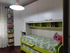 a childs room with a bunk bed and bookshelves at Dimora C&A in Mondragone