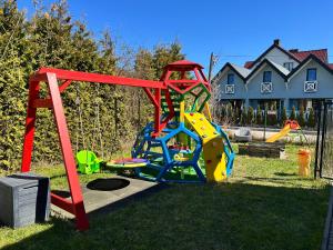 a playground in a yard with a play structure at Poprzeczna 7 in Sarbinowo