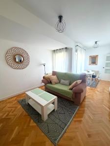 a living room with a couch and a coffee table at VUT Torreón de los Guzmanes in Ávila