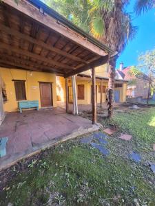 a porch of a house with a blue bench at La Rocca in Colón