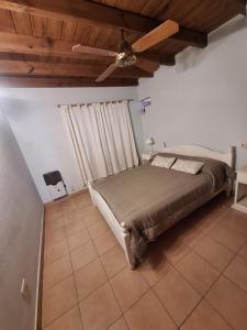 a bedroom with a bed and a ceiling fan at La Rocca in Colón