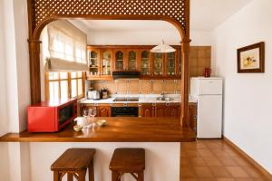 a kitchen with a wooden counter top and a refrigerator at Deluxe Mogán Beach Apt 1 in Puerto de Mogán