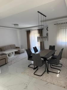 a dining table and chairs in a living room at Lux Villa Azur in Bar +7 photos